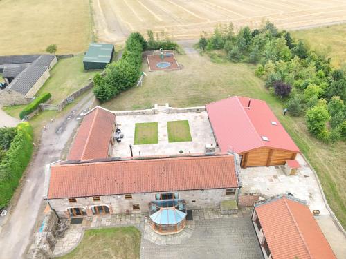an aerial view of a building with a basketball court at The Estate, Luxury Spacious Family Stay with 3 Hot Tubs, Scenic Views Sleeps 16 near Durham & Bishop Auckland in Durham