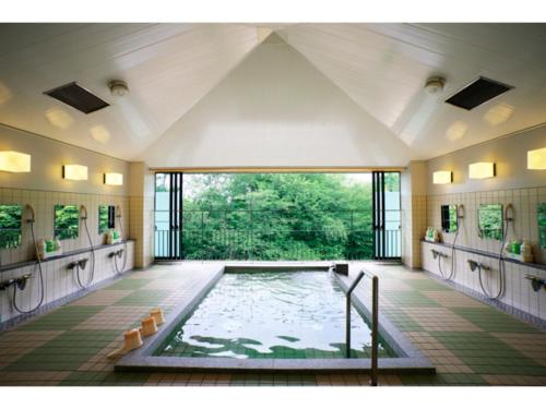 a large room with a swimming pool with a large window at Utano Youth Hostel - Vacation STAY 50485v in Kyoto