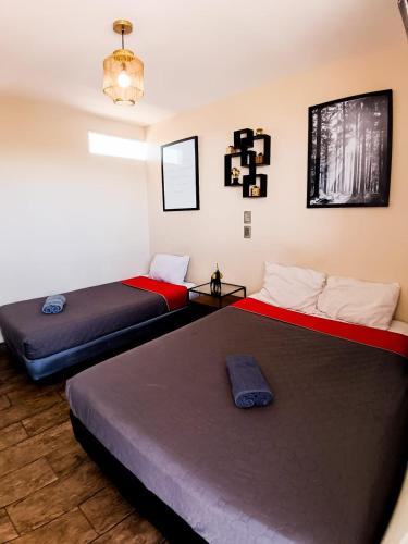 a room with two beds in a room at Golden Vintage Room , Paseo Durango in Durango