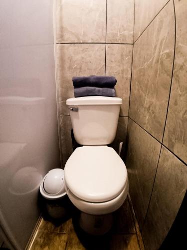 a bathroom with a toilet with a blue towel on it at Golden Vintage Room , Paseo Durango in Durango