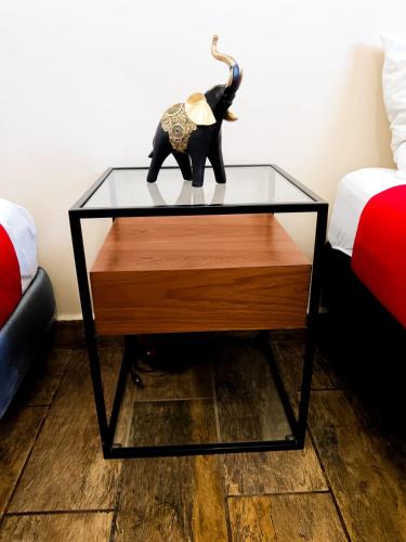 a glass table with an elephant toy on top of it at Golden Vintage Room , Paseo Durango in Durango