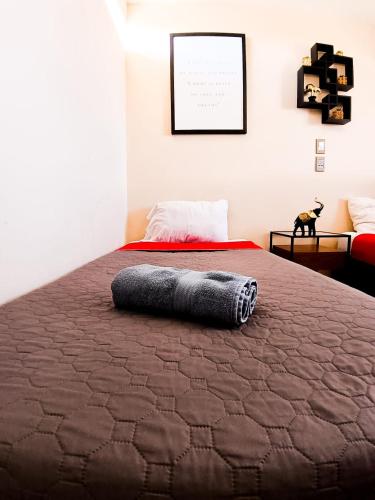 a bedroom with a bed with a blanket on it at Golden Vintage Room , Paseo Durango in Durango