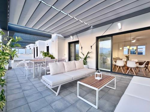 a living room with a couch and a table at Playa Granada Apartamentos Moriscos II in Motril