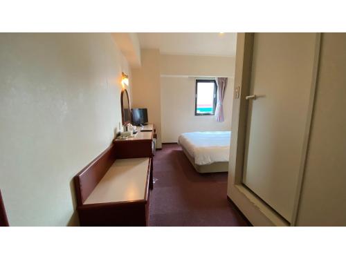 a hotel room with a bed and a desk at Smile Hotel Kitaasaka - Vacation STAY 69671v in Asaka