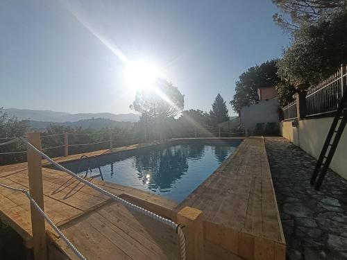 a swimming pool with the sun in the background at Villa Pacchini Wellness & Relax Retreat in Poggio Mirteto