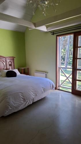 a bedroom with a bed and a large window at Neike Hotel Boutique in Punta del Este