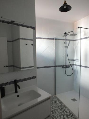 a bathroom with a sink and a glass shower at Casa Walt in Mojácar