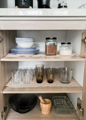 a shelf with dishes and glasses in a kitchen at Large apartment airport Guatemala City in Estación Pamplona