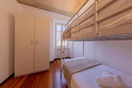 a bedroom with two bunk beds and a window at Contempora Apartments - Ca' Brenta Fresco in San Fedele Intelvi