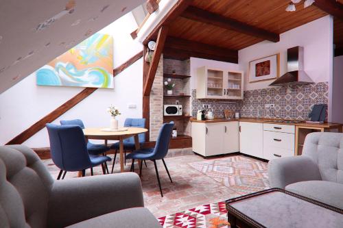 a kitchen and dining room with a table and chairs at Art Maison Krumlov in Český Krumlov