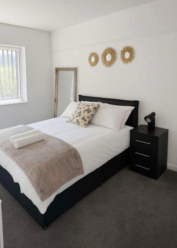 a bedroom with a large bed with two mirrors on the wall at Richmond Nights