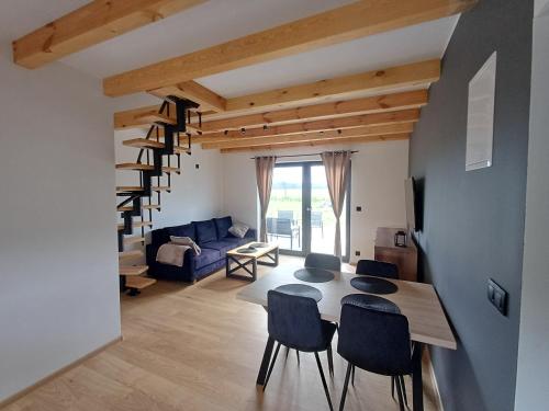 a living room with a table and chairs and a couch at Przystań Łukęcin in Łukęcin