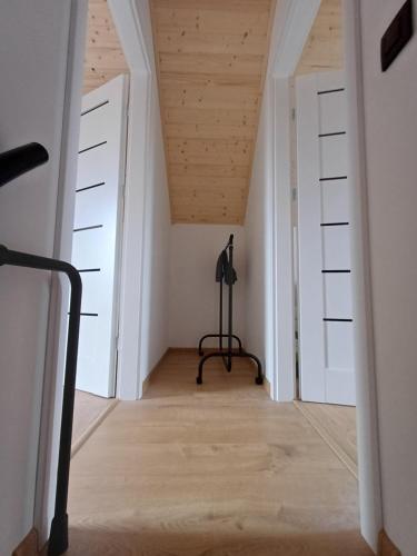 a room with white walls and a wooden ceiling at Przystań Łukęcin in Łukęcin