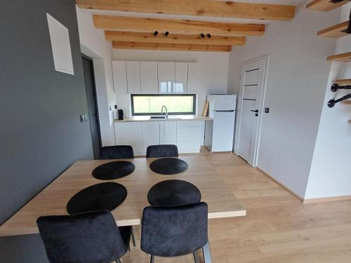 a kitchen and dining room with a table and chairs at Przystań Łukęcin in Łukęcin