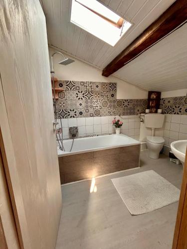 a bathroom with a tub and a toilet and a sink at Apt Versilia in Viareggio