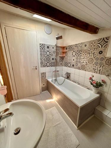 a bathroom with a tub and a sink at Apt Versilia in Viareggio