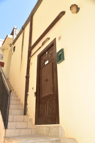 a brown door on the side of a building at MEITHRAS holiday homes in Agrigento