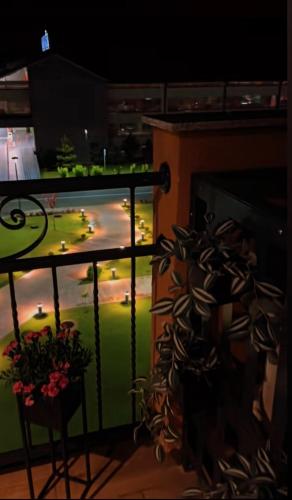 a balcony with a vase of flowers next to a fireplace at Fruške 202 studio apartman in Vrdnik