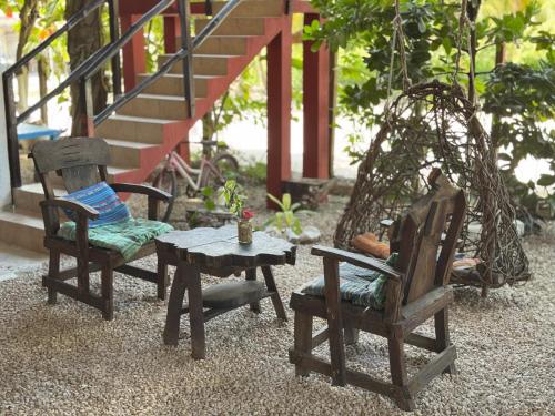 two chairs and a table in front of a house at El árbol de la vida Hostel - Private Rooms Near Bacalar Lagoon in Bacalar