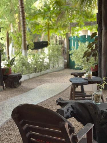 a park with a bench and a table and trees at El árbol de la vida Hostel - Private Rooms Near Bacalar Lagoon in Bacalar