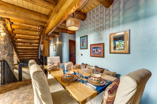 a dining room with a long table and chairs at Secluded Angel Fire Retreat Deck and Stunning View! in Angel Fire