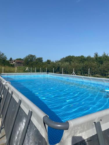 a large swimming pool with blue water at Obedska Bara - Kupinovo Retreat House in Kupinovo