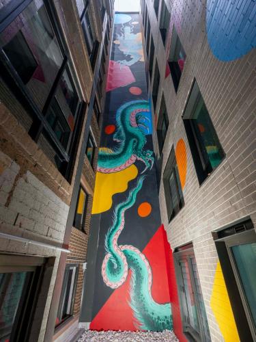 a hallway with a painting on the side of a building at Adge Hotel and Residences in Sydney