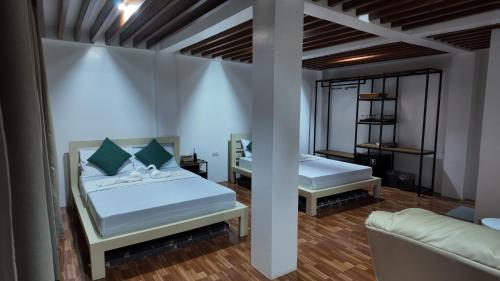 a bedroom with two beds and a couch at Casa Brisa Resort in Kayagan