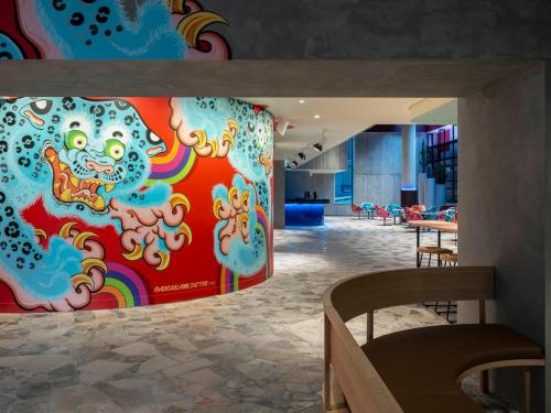 a room with a wall with a painting on it at Adge Hotel and Residences in Sydney