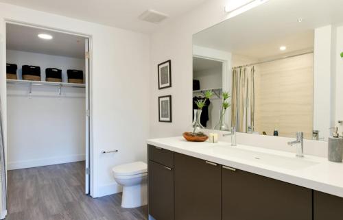 a bathroom with a sink and a toilet and a mirror at Chill room in Oakland