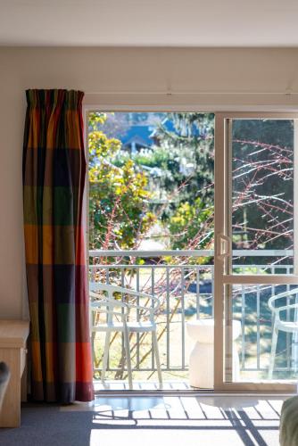 a sliding glass door with a view of a balcony at Tussock Peak Lodge in Hanmer Springs