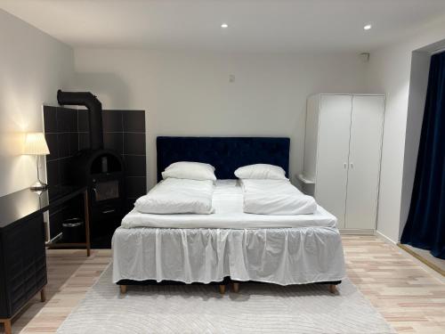 a bedroom with a large bed with white sheets and pillows at Nordnest, 6 min from Airport in Copenhagen