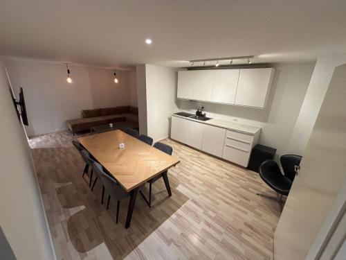 a kitchen and dining room with a table and chairs at Nordnest, 6 min from Airport in Copenhagen