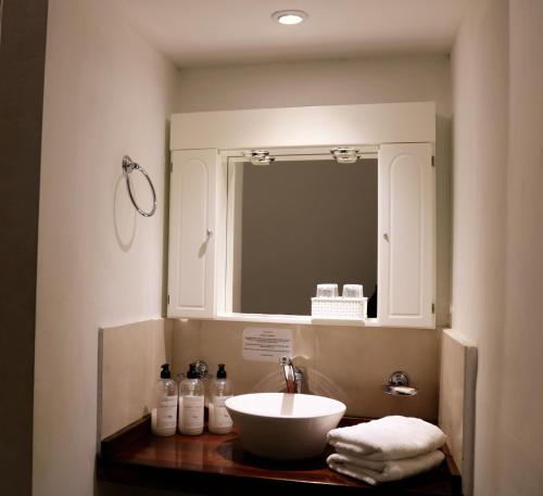 a bathroom with a sink and a mirror at Portal de La Cumbre in La Cumbre