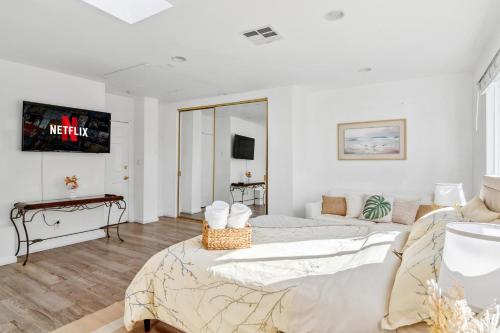 a white room with a bed and a couch at Quiet Home with Spectacular Scenic Mountain Views near Universal Studios Hollywood in Los Angeles