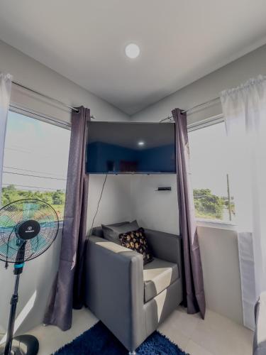 a living room with a couch and a window at Two Bedroom Suite - 12min from UVF Airport in Vieux Fort