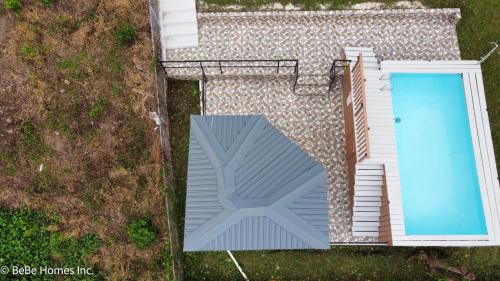 an overhead view of a swimming pool next to a house at Two Bedroom Suite - 12min from UVF Airport in Vieux Fort