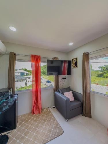 a living room with a couch and a tv at Two Bedroom Suite - 12min from UVF Airport in Vieux Fort