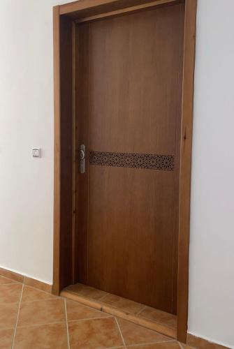a wooden door in the middle of a room at Vue Mer Tamernout in Aouchtame