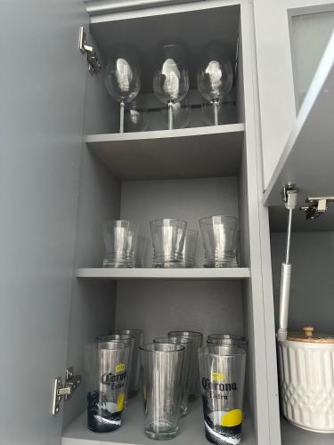 a cupboard with a bunch of cups and bowls at The Lake house 305 , Perfect Sunset in Tamiami