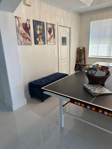 a ping pong table in a living room with a couch at The Lake house 305 , Perfect Sunset in Tamiami