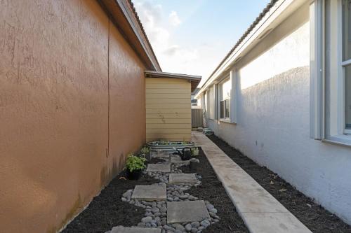 a side walk next to a building with rocks at The Lake house 305 , Perfect Sunset in Tamiami