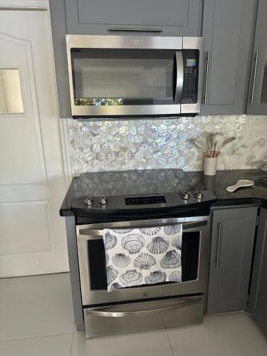 a kitchen with a stove and a microwave at The Lake house 305 , Perfect Sunset in Tamiami
