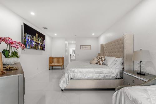 a white bedroom with a bed and a desk at The Lake house 305 , Perfect Sunset in Tamiami