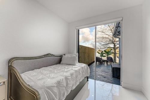 a bedroom with a bed and a sliding glass door at The Lake house 305 , Perfect Sunset in Tamiami