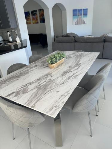 a marble table in a living room with a couch at The Lake house 305 , Perfect Sunset in Tamiami