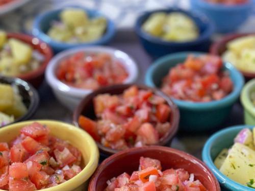 a table topped with bowls of different types of food at Ouirgane discovery lodge in Ouirgane