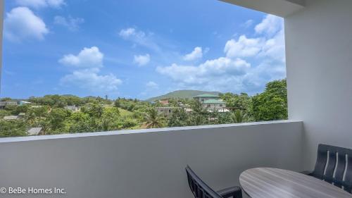 a window with a view of a mountain at Villa Opulence - 12min from UVF Airport in Vieux Fort