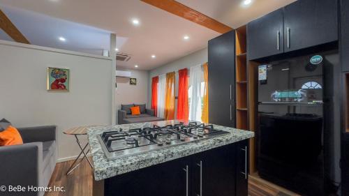 a kitchen with a stove top in a room at Villa Opulence - 12min from UVF Airport in Vieux Fort