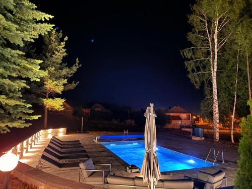 a pool at night with a closed umbrella at Uvac lake "FF" in Sjenica